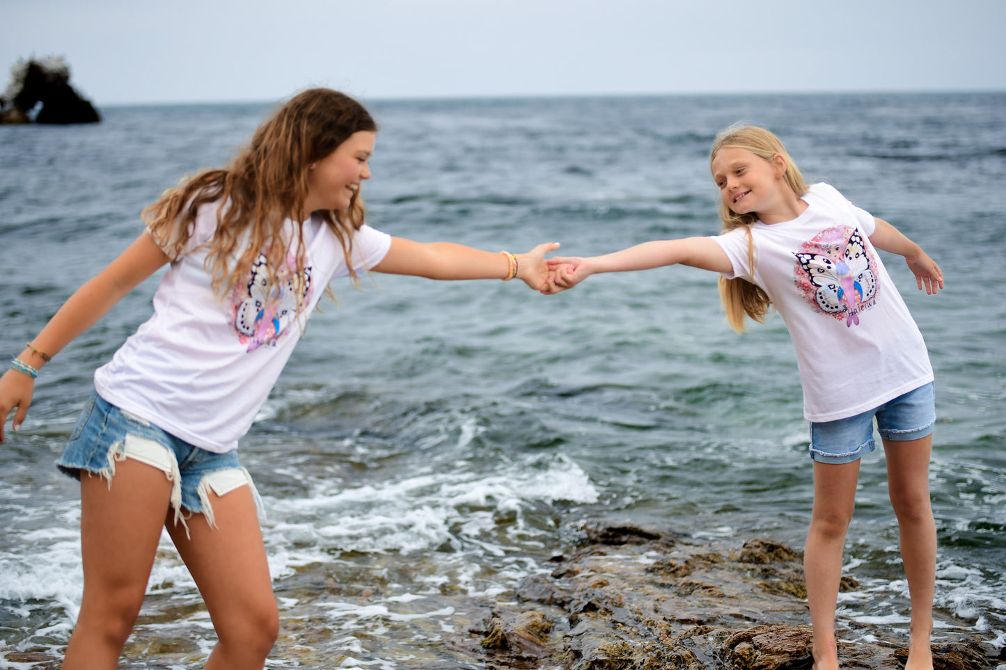 Haleiwa-inspired mermaid graphic tee for girls, with vibrant florals and butterfly wings design.