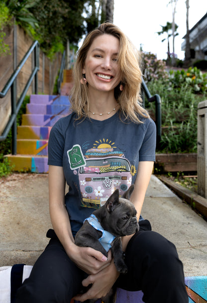 Woman in a blue North Shore Girls graphic t-shirt features a hand-drawn vintage floral beach van.
