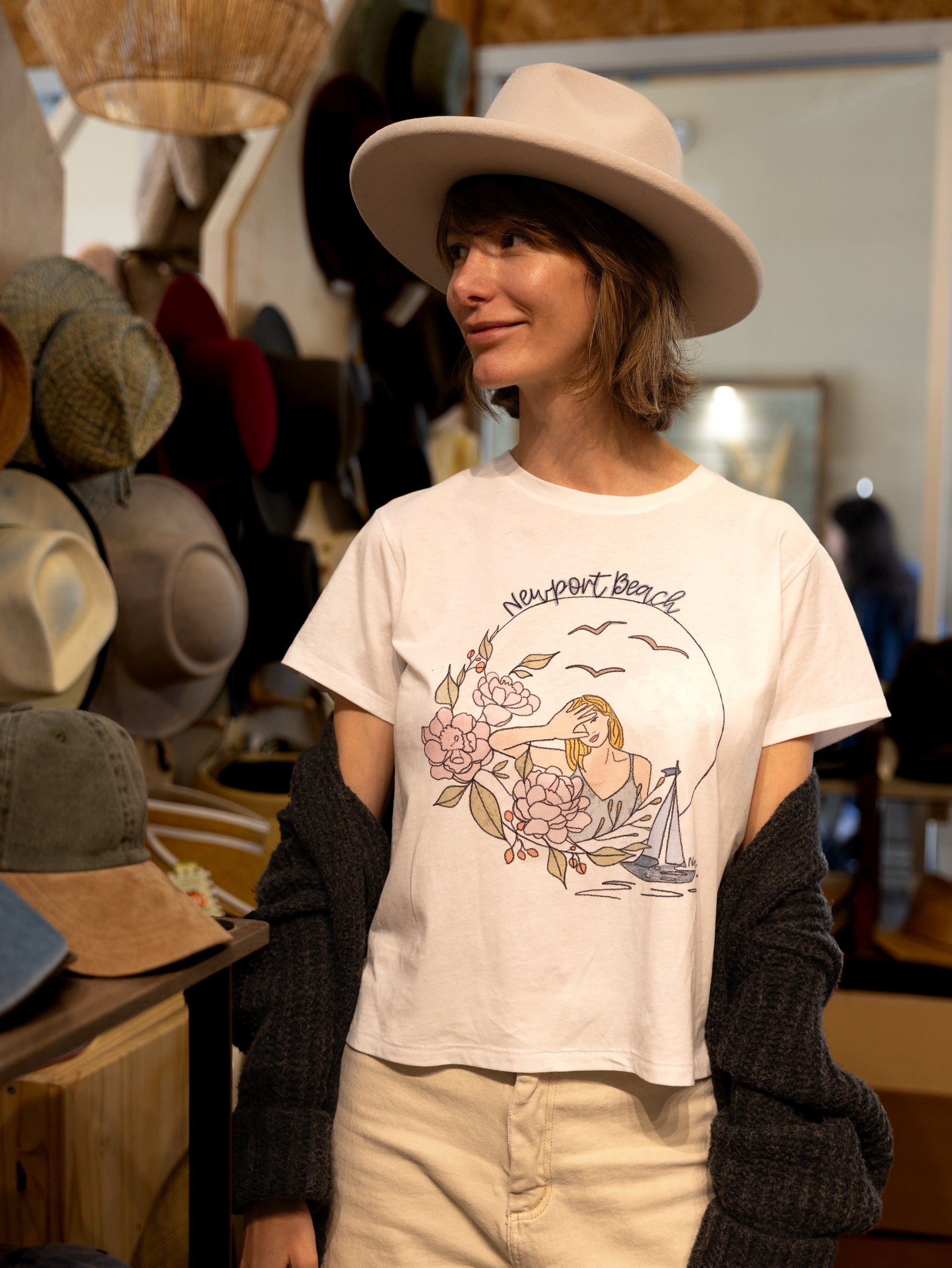 Nadia Watts-artist and designer for North Shore Girls brand. Wearing  Newport Beach illustrated  beach city destination graphic t-shirt