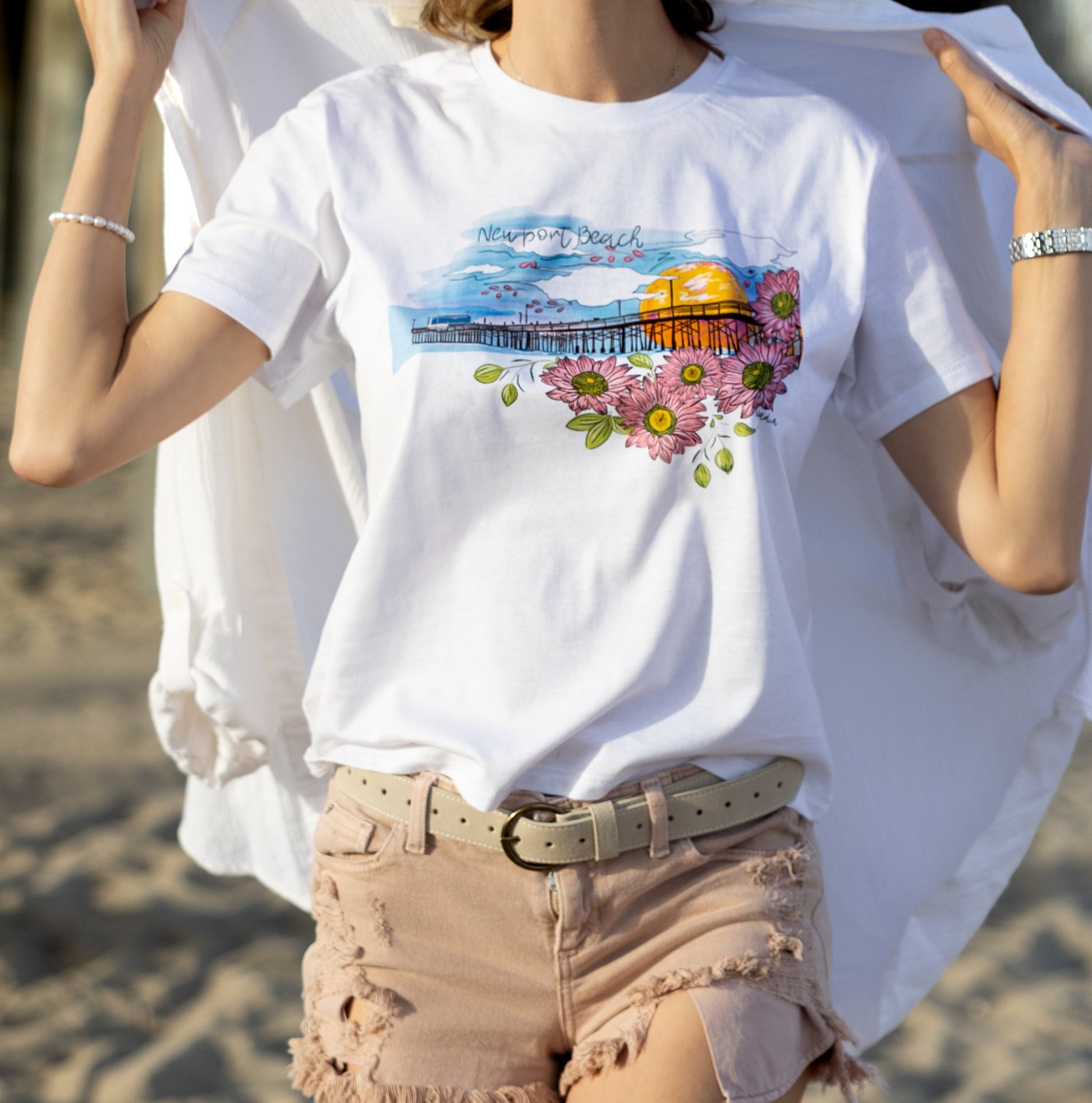 Soft women's tee featuring a hand-drawn design of Newport Beach Pier on 100% premium cotton.