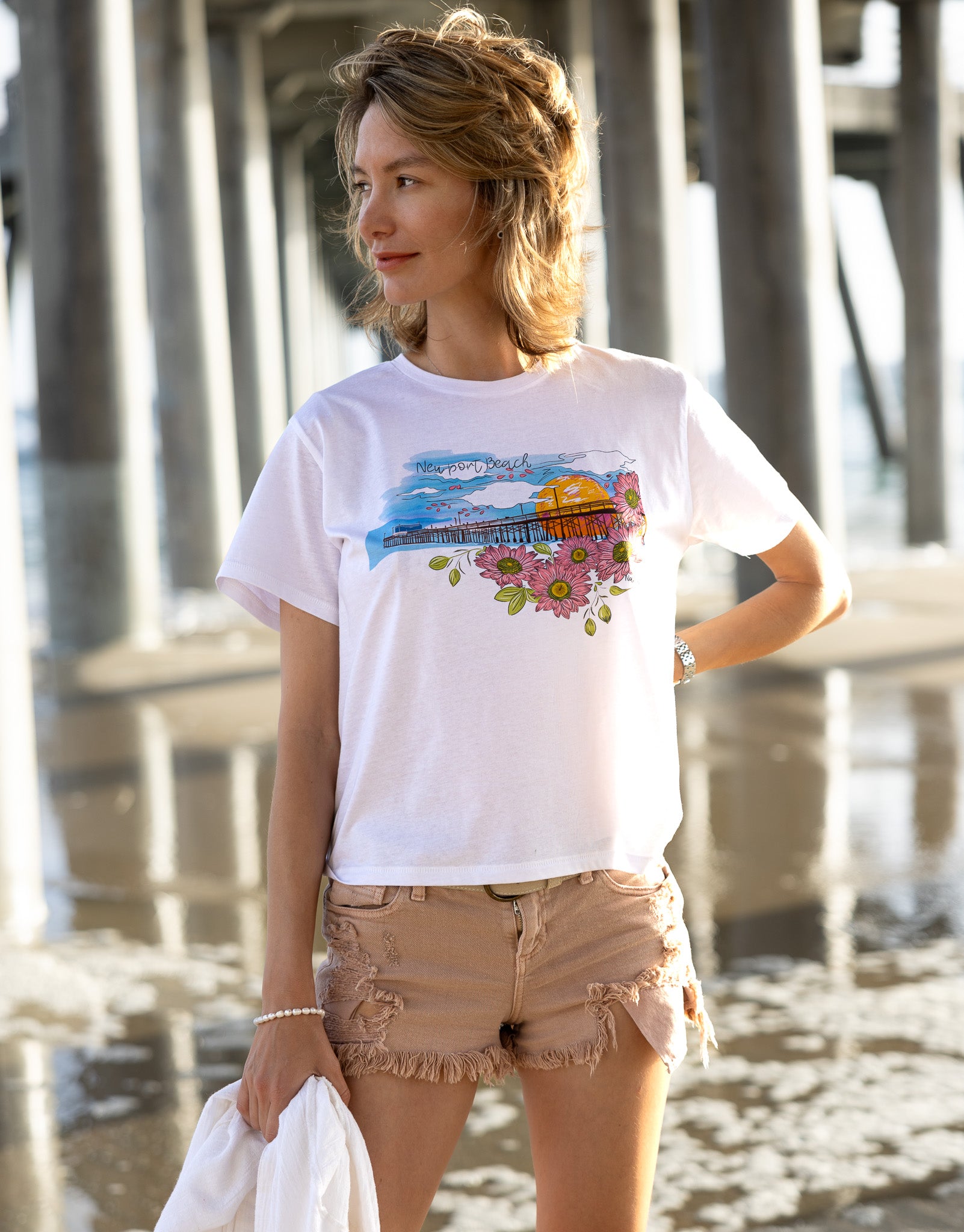 Soft women's tee featuring a hand-drawn design of Newport Beach Pier on 100% premium cotton.