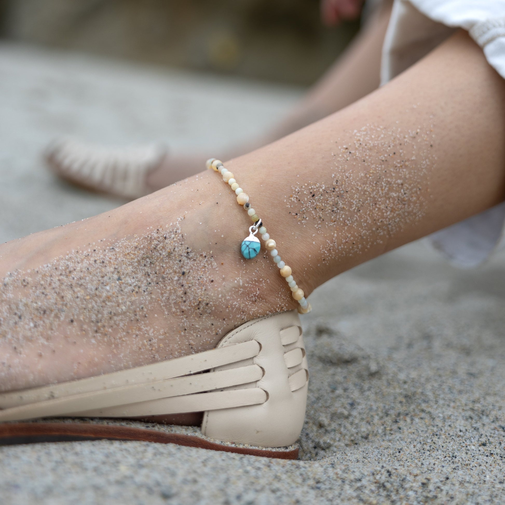 Handmade Cali Coast Ankle Bracelet with turquoise charm and pastel blue beads on stretchy string, perfect for beachy style