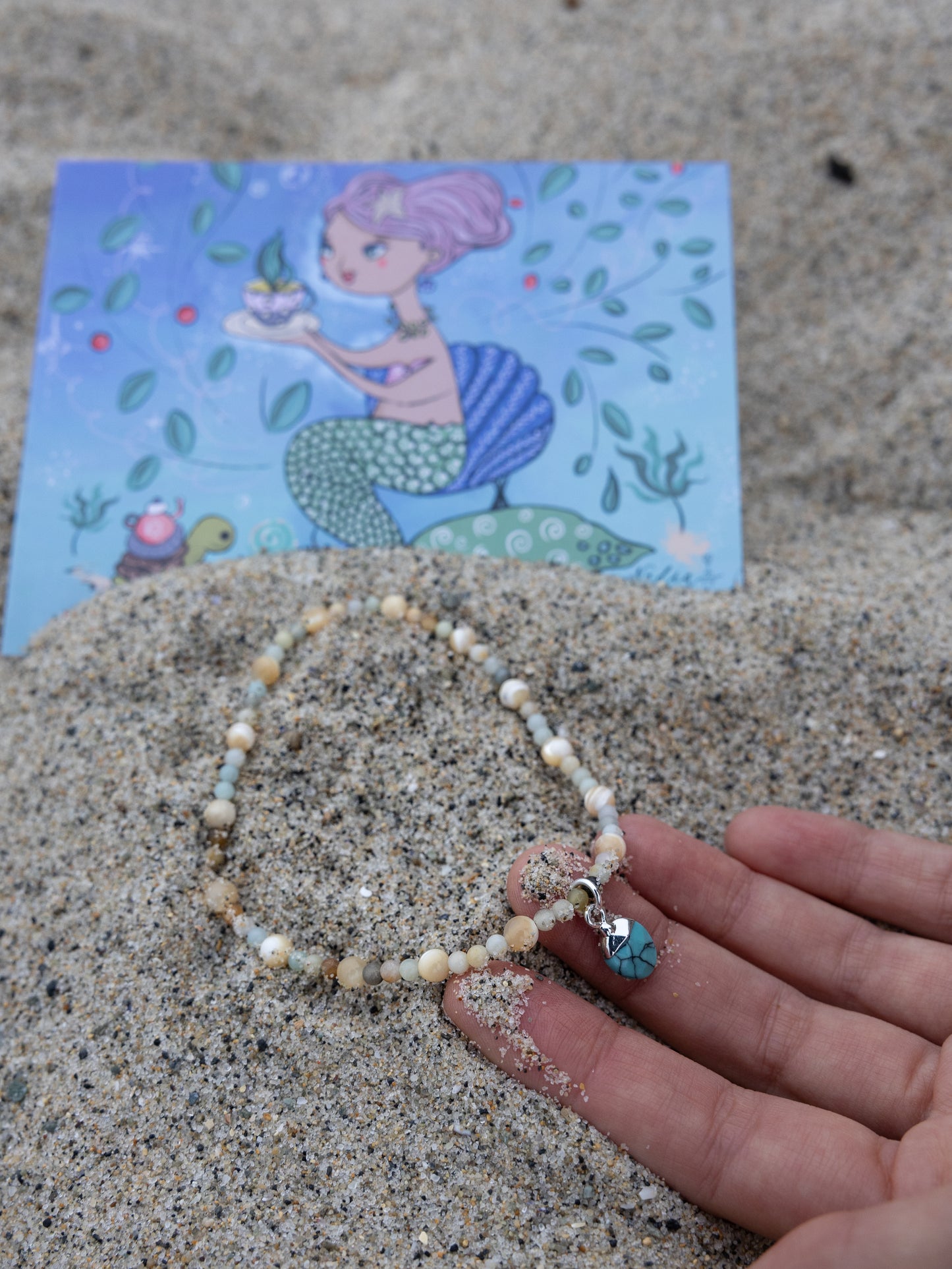 Handmade Cali Coast Ankle Bracelet with turquoise charm and pastel blue beads on stretchy string, perfect for beachy style