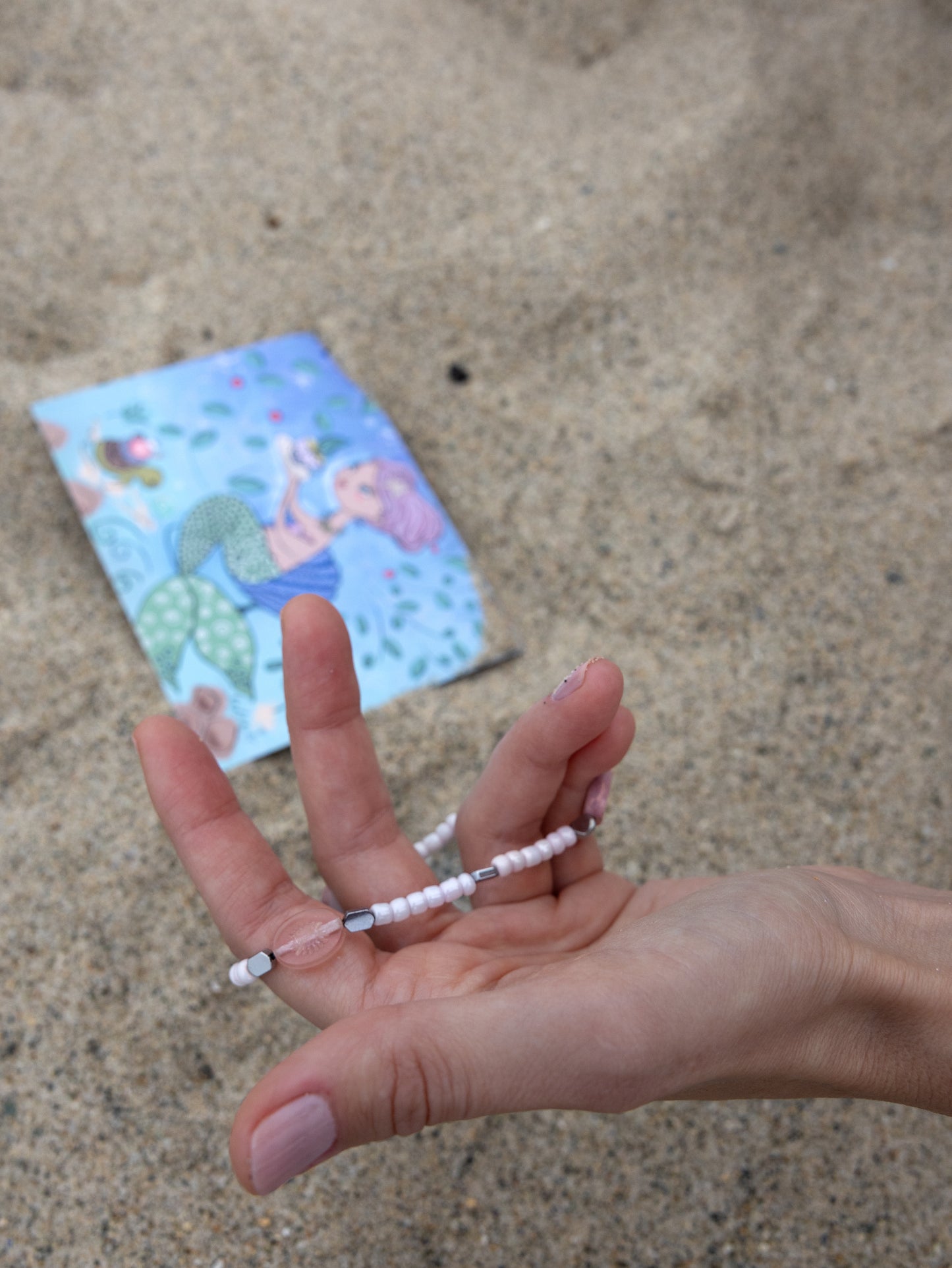 Handmade beach-inspired bracelet with light pink beads