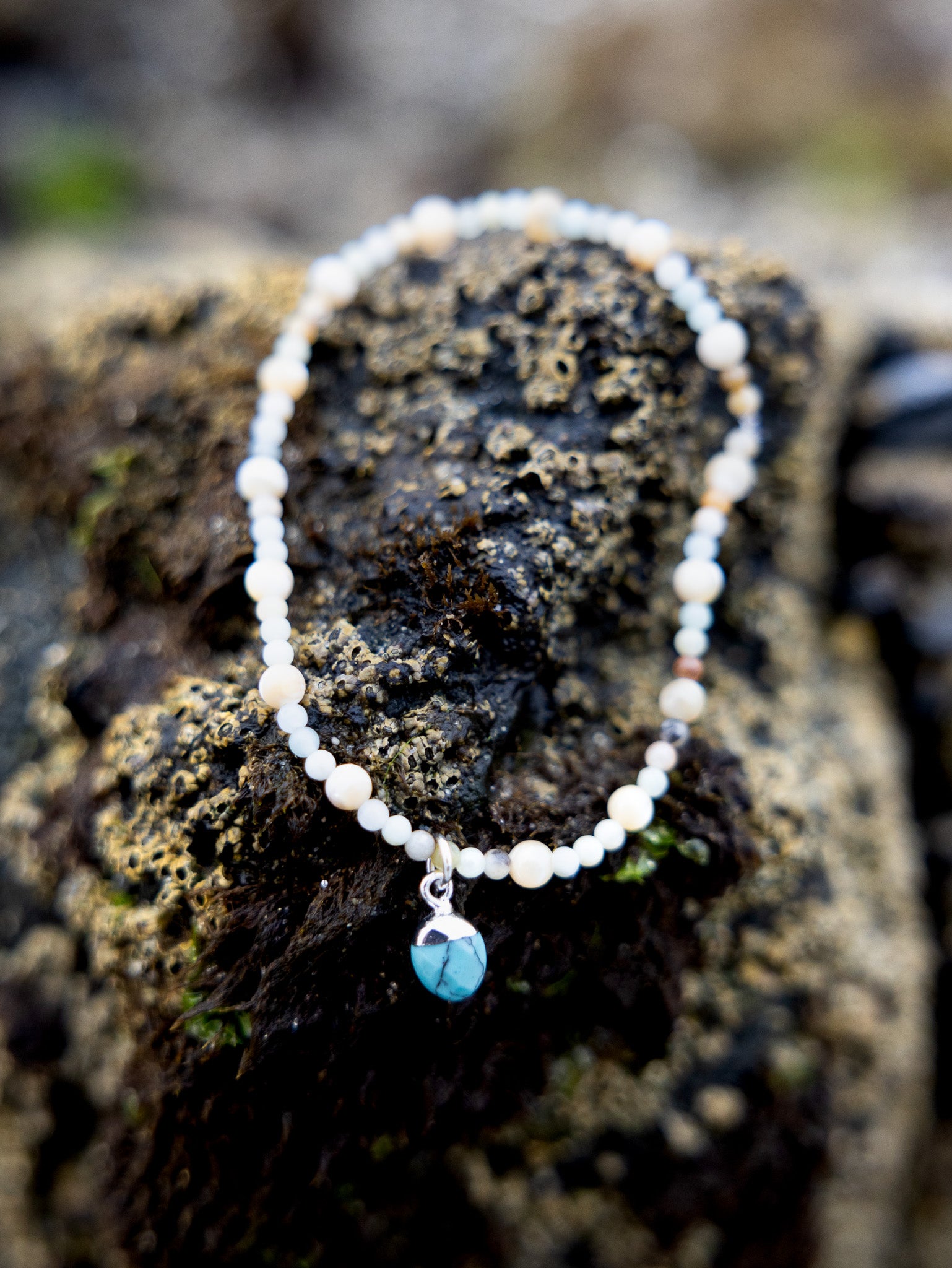 Handmade Cali Coast Ankle Bracelet with turquoise charm and pastel blue beads on stretchy string, perfect for beachy style