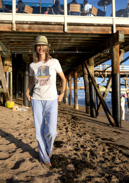 Hand‑illustrated mermaid snuggled in a sardine can on a soft cotton women’s tee – Southern California vibe