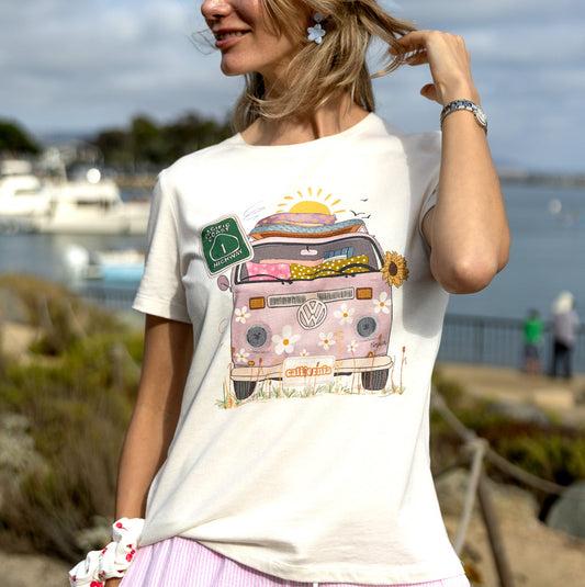A woman is wearing a tee with pink hippie bus