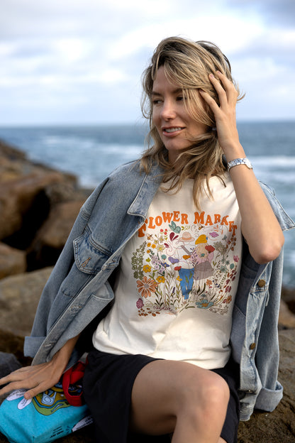 Romantic couple walking among flowers on a soft cotton tee
