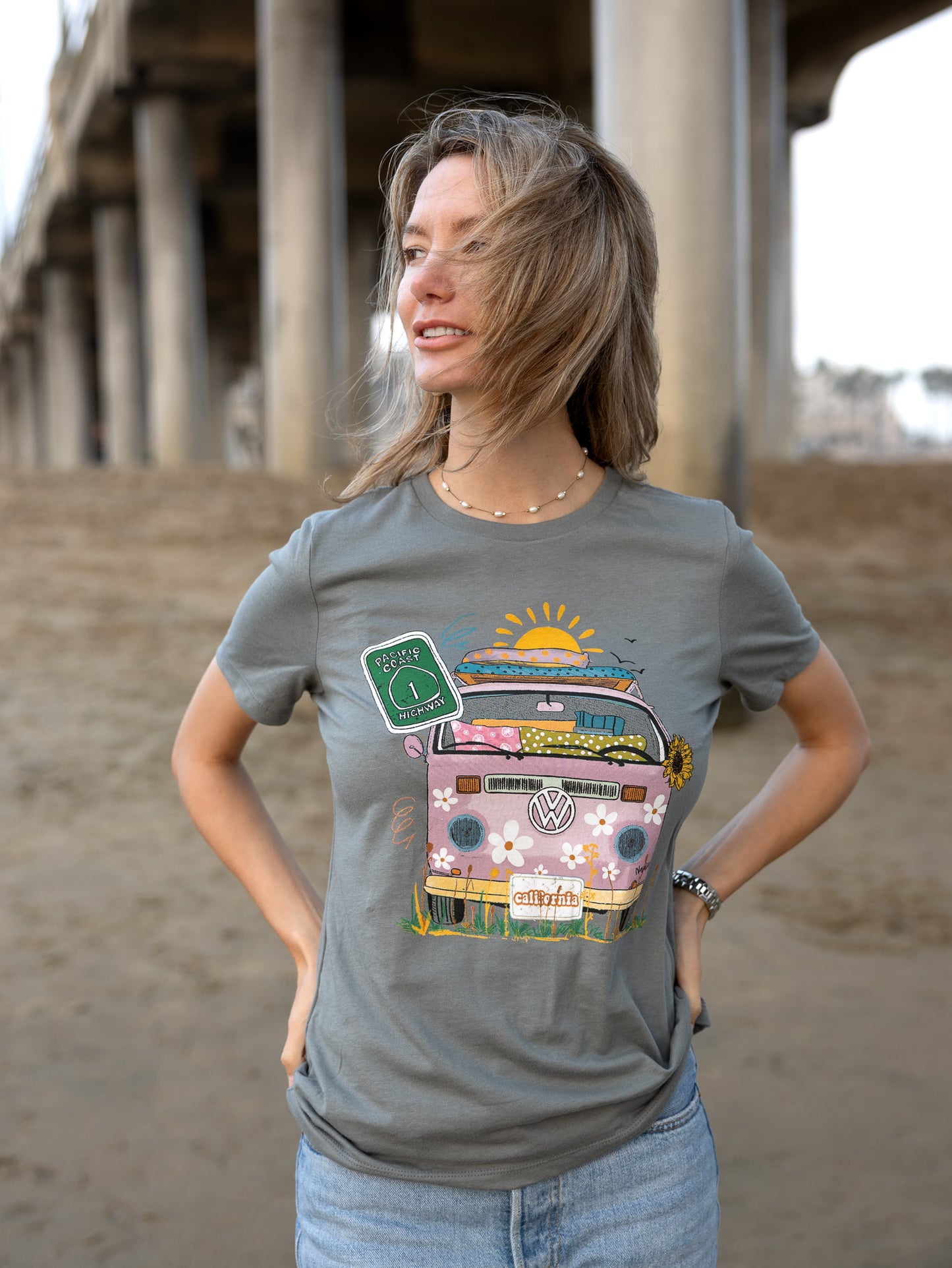 Woman in a greyNorth Shore Girls graphic t-shirt features a hand-drawn vintage floral beach van.