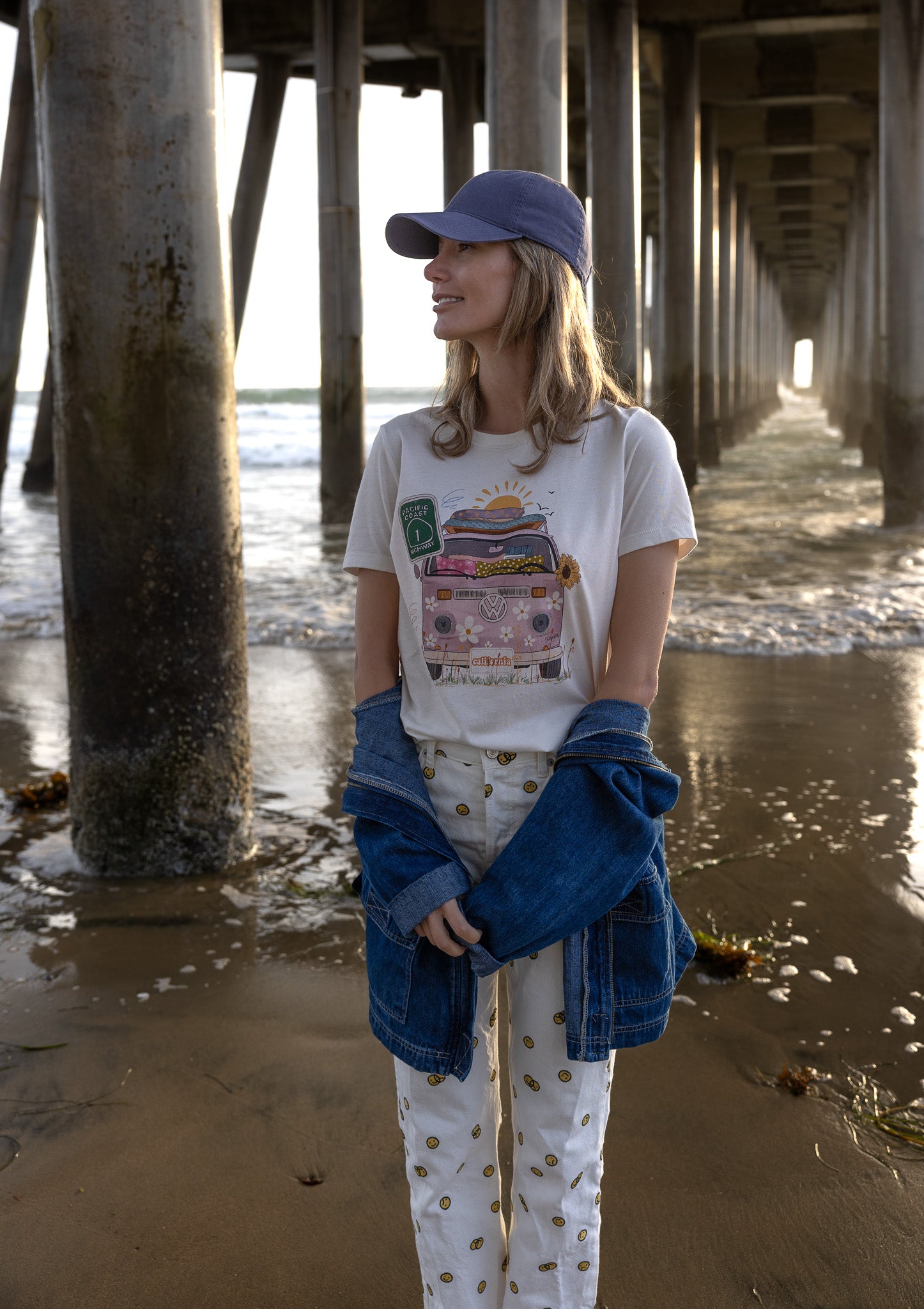 Pink VW bus graphic tee with floral details and “California” license plate, hand‑illustrated design on soft cotton