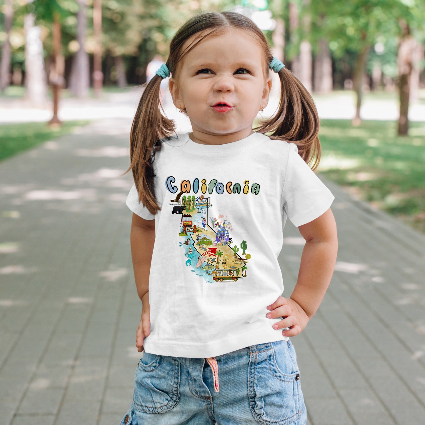 White toddler t-shirt featuring a colorful, hand-drawn map of California with coastal landmarks, part of the North Shore Kids collection.