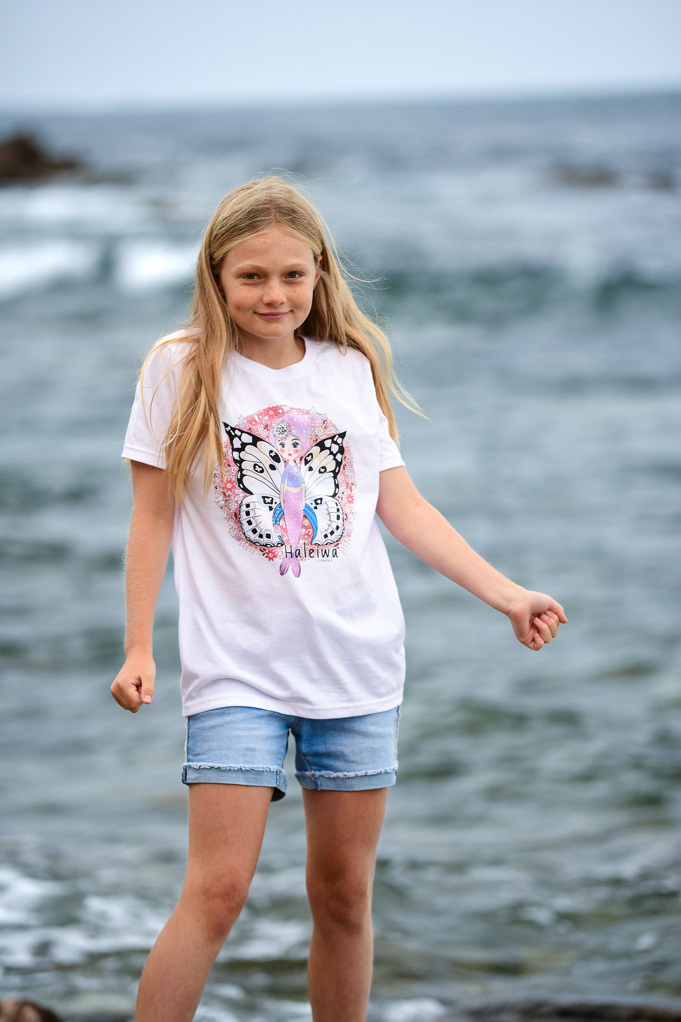 North shore girls graphic t-shirt featuring Haleiwa mural wings and cute mermaid with flowers.