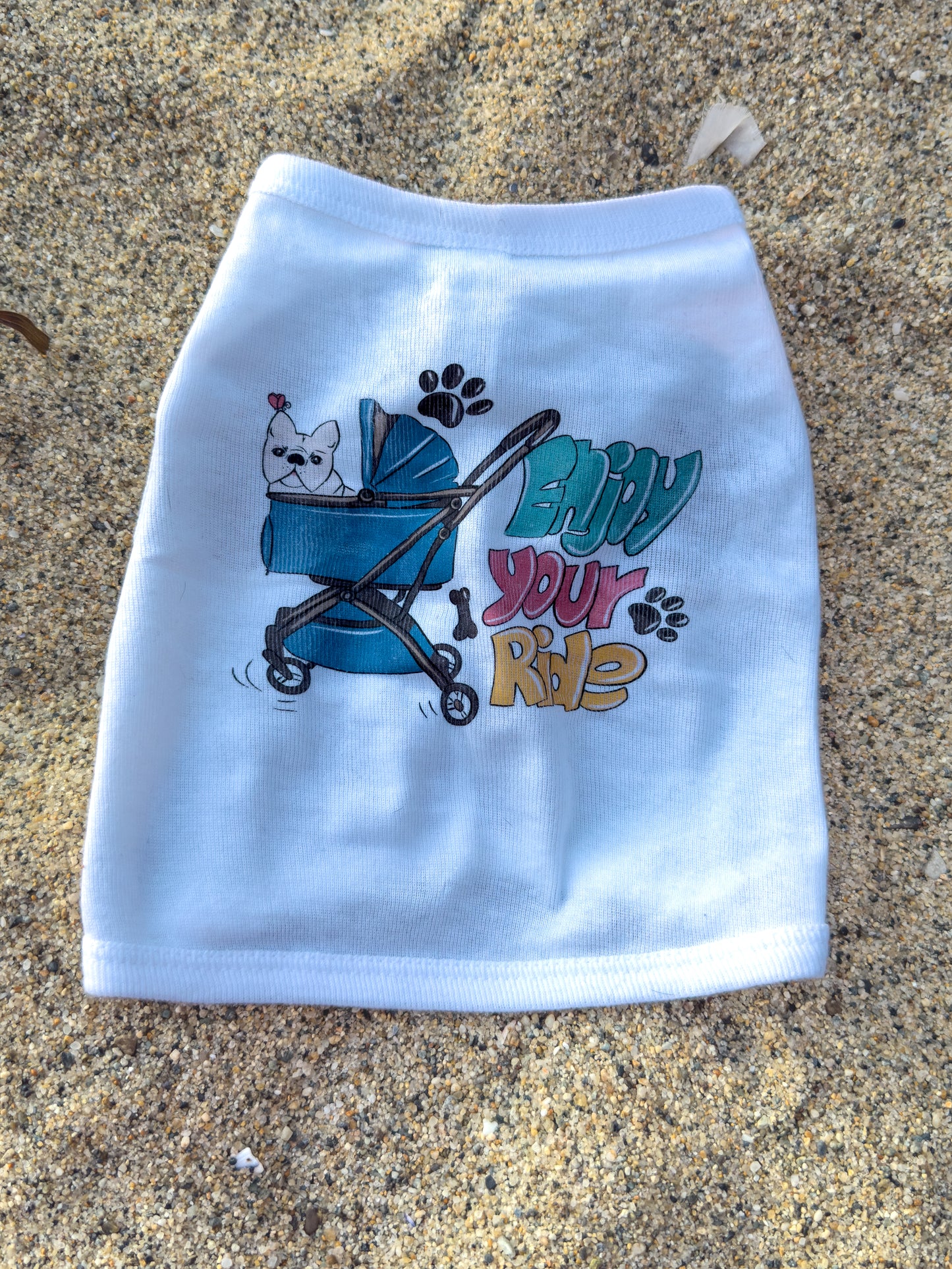 White dog t-shirt with cartoon design and text on a textured surface