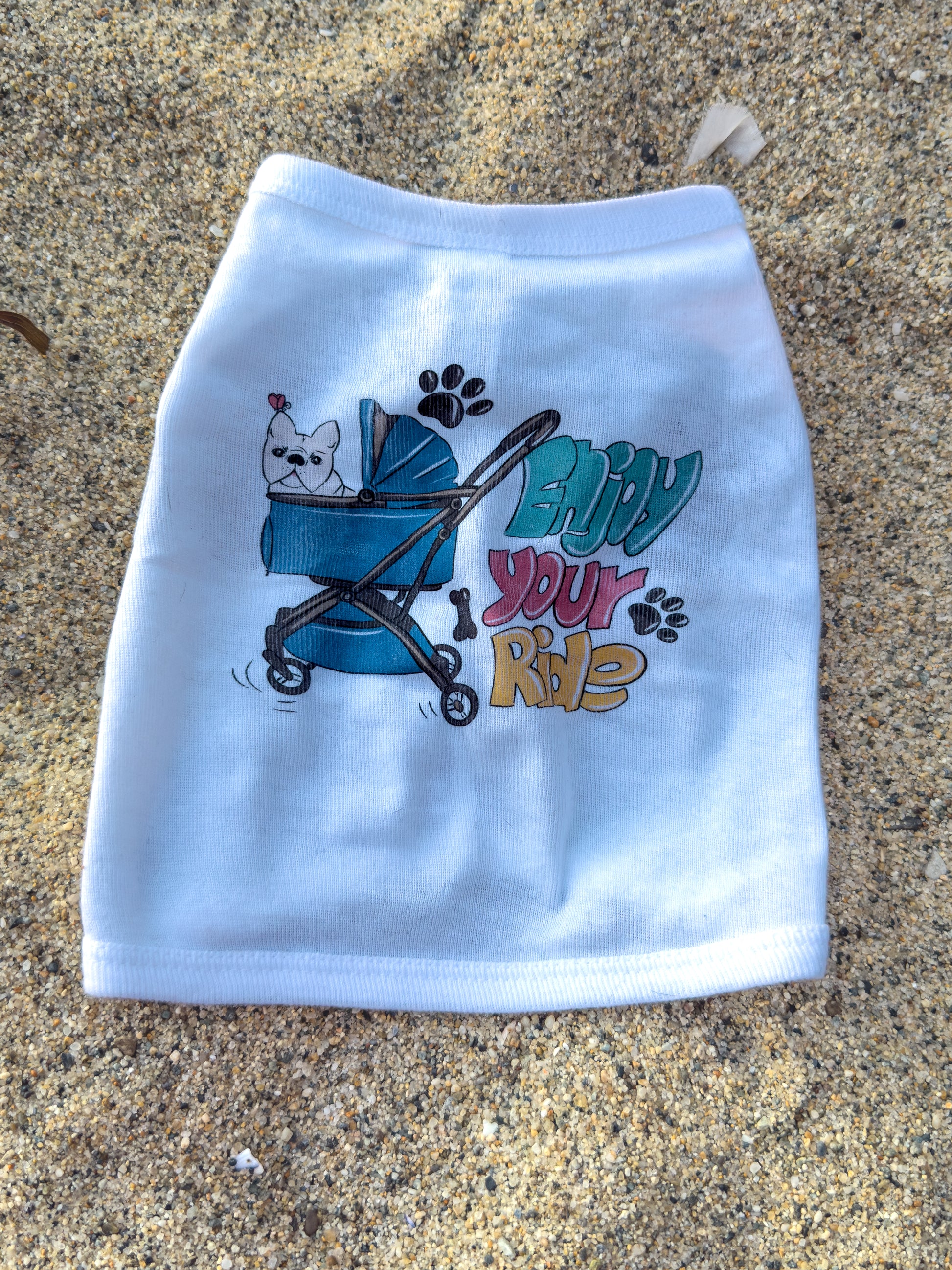 White dog t-shirt with cartoon design and text on a textured surface