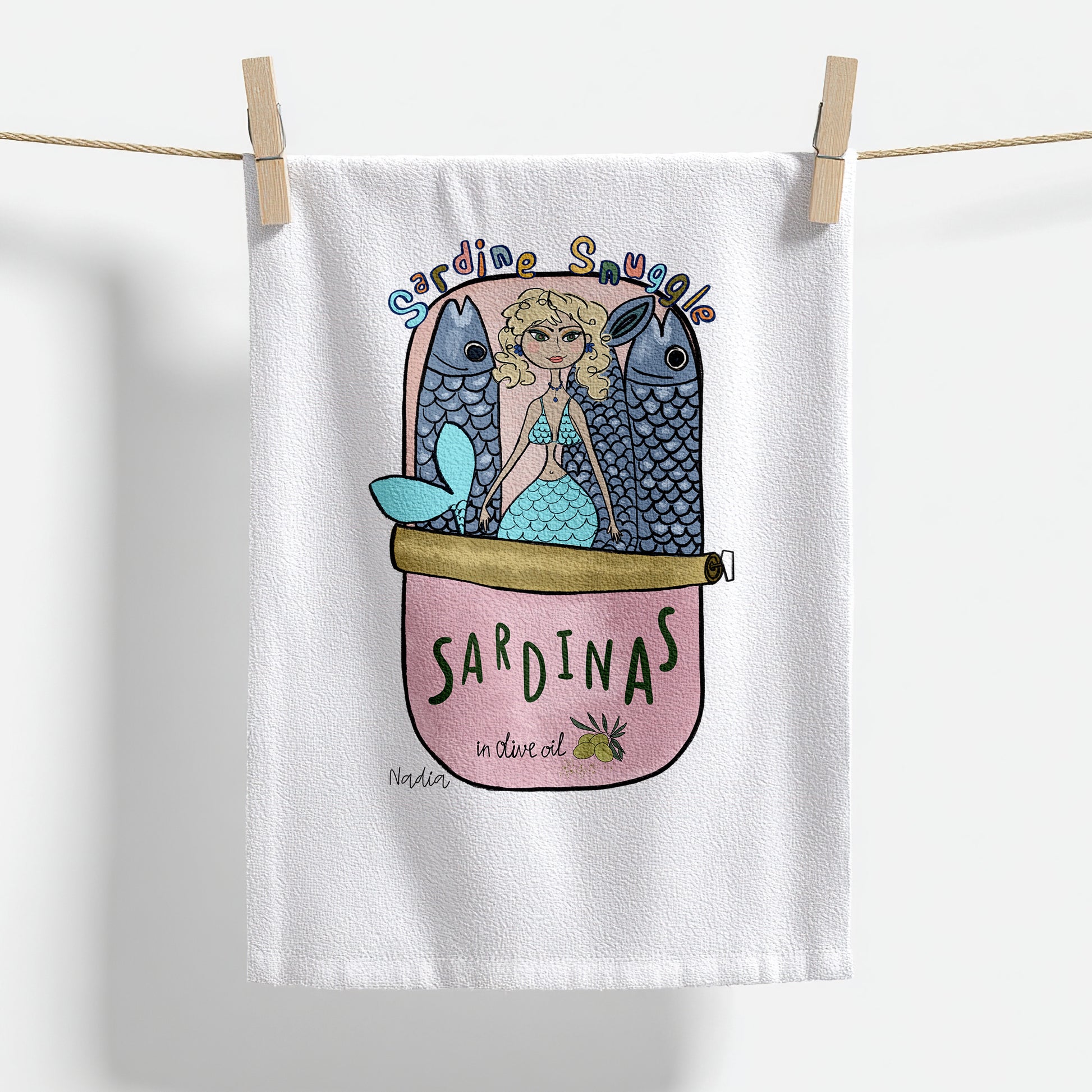 18x28 inch white thin cotton kitchen towel with a mermaid in a pink sardine tin illustration signed by Nadia Watts