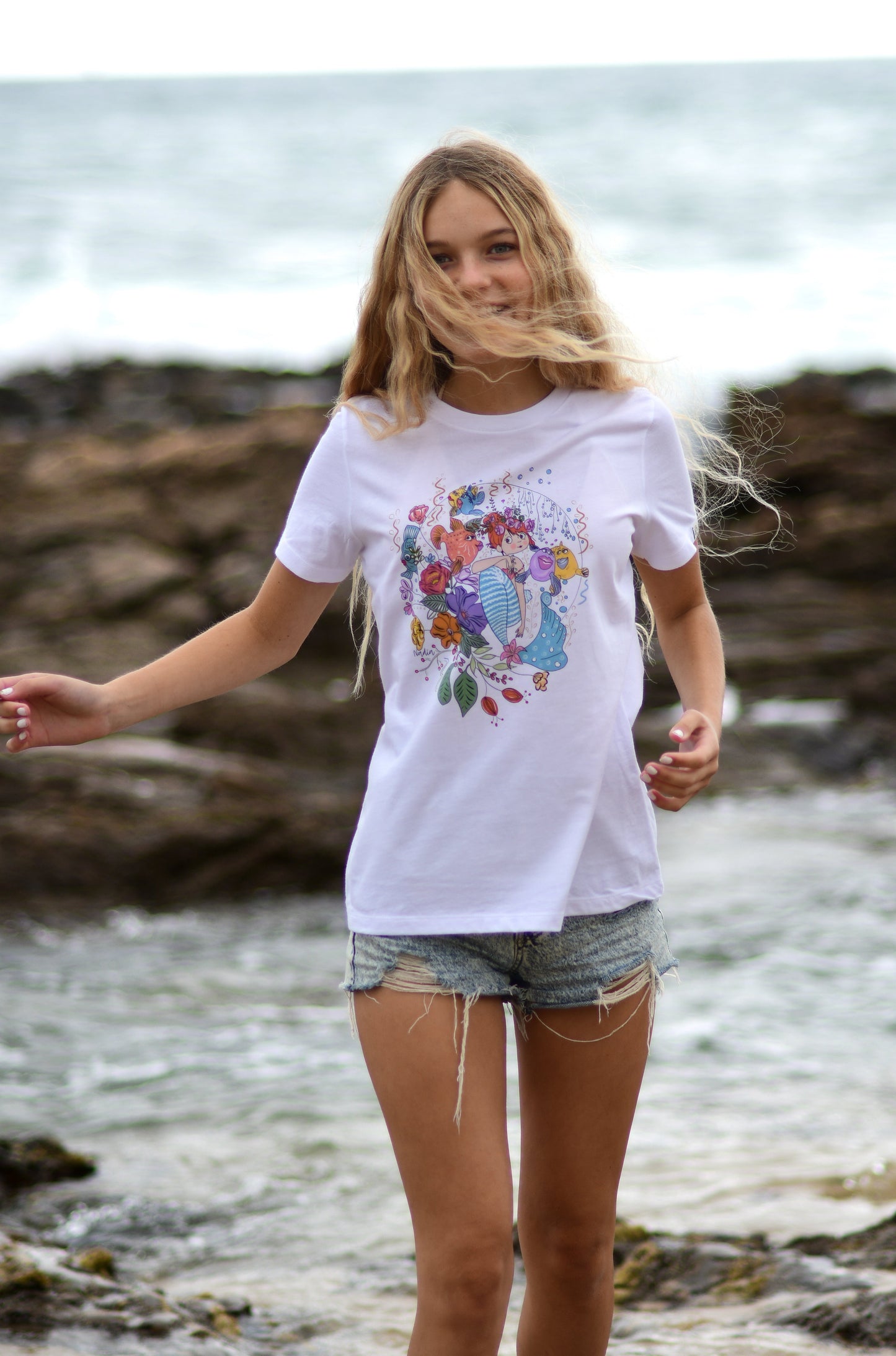 Red headed mermaid fish and floral graphic design beach surf t-shirt for women. Wearable art handmade by Nadia Watts. North Shore Girls graphic tee collection. Hand-drawn illustrated clothing for the beach lifestyle