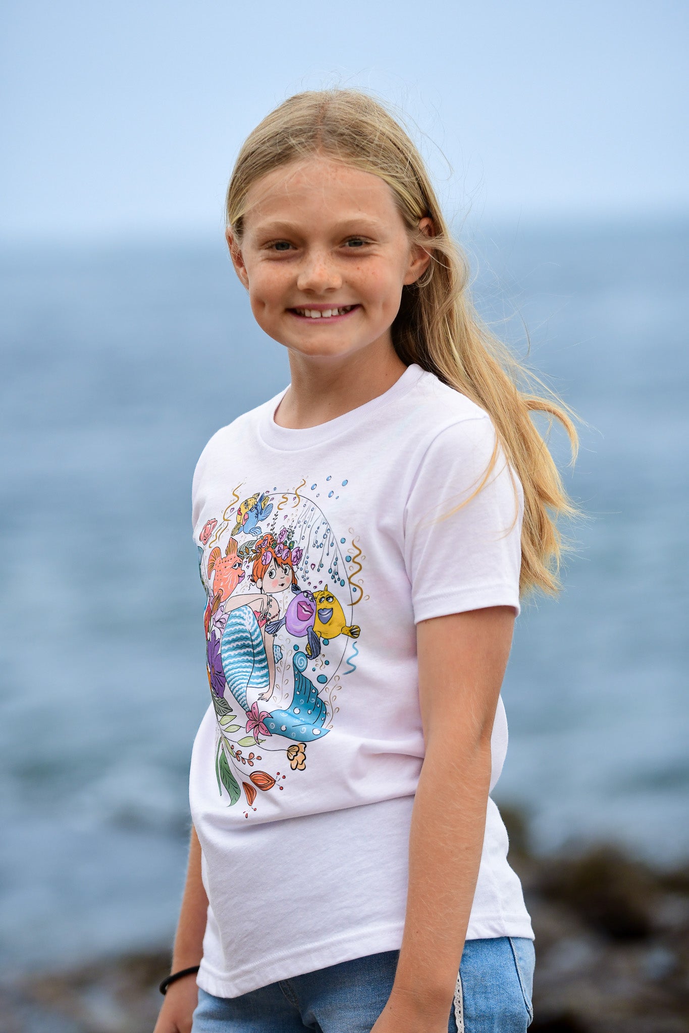 Mermaid graphic tee for girls. red headed mermaid and her sea creatures friends hand-drawn illustration t-shirt . Made in Southern California