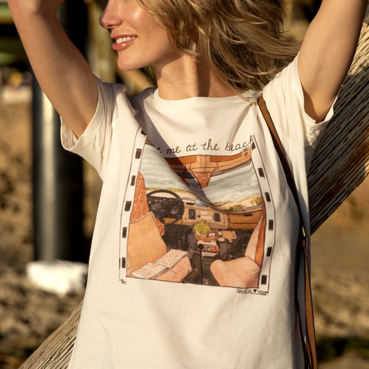 Women's cream-colored tee with a hand-drawn vintage car interior and Meet Me at the Beach text.