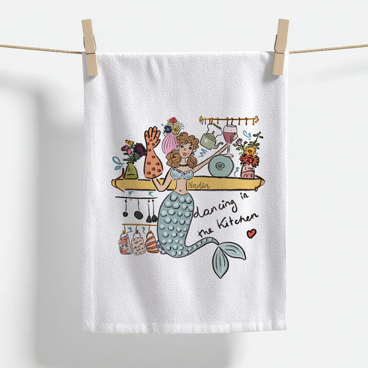 Shop North Shore Girls. This 18x28 inch premium thin cotton kitchen towel features a dancing mermaid illustration signed by Nadia Watts.