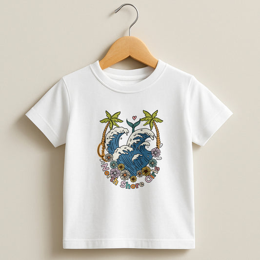 White toddler t-shirt featuring a hand-drawn ocean wave crest with palm trees and flowers, part of the North Shore Kids collection