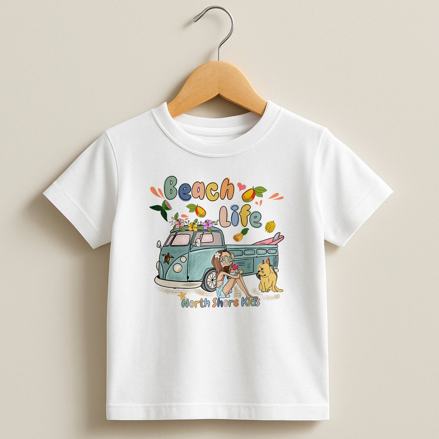 White toddler t-shirt featuring a hand-drawn surf girl with a surfboard in her van, a dog, and fruits, part of the North Shore Kids collection.