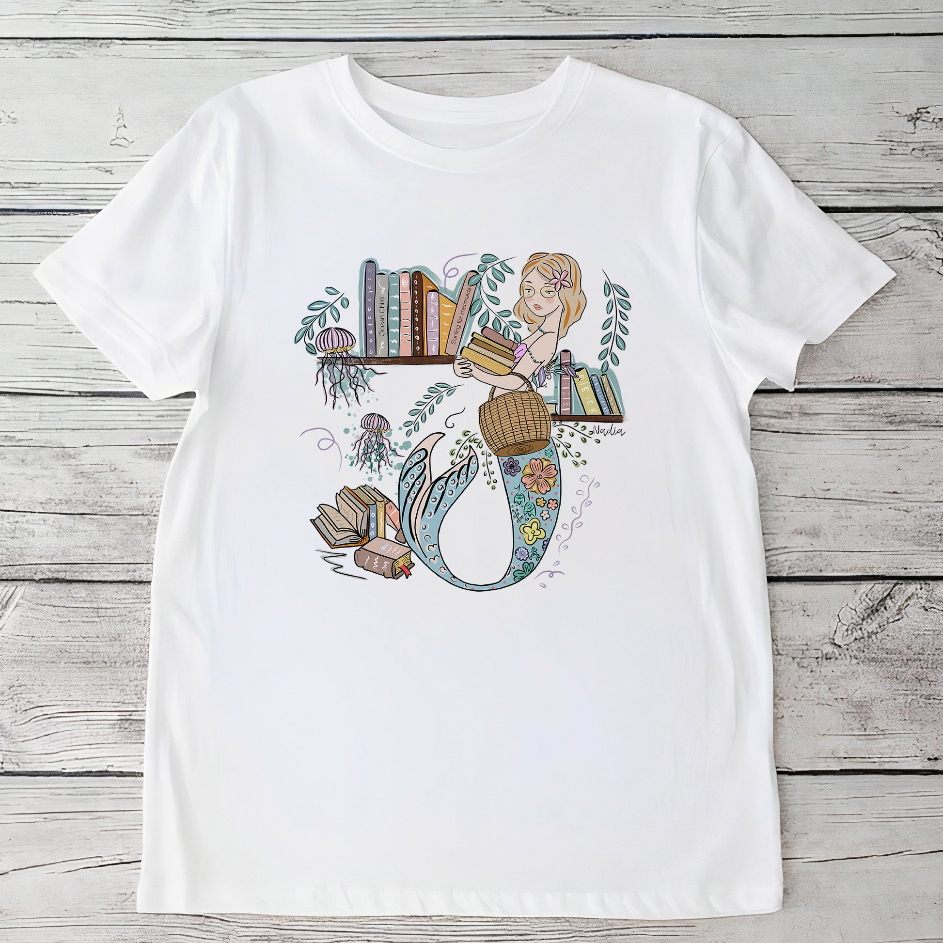 Youth white t-shirt with a hand-drawn mermaid librarian and books in a bohemian underwater setting.