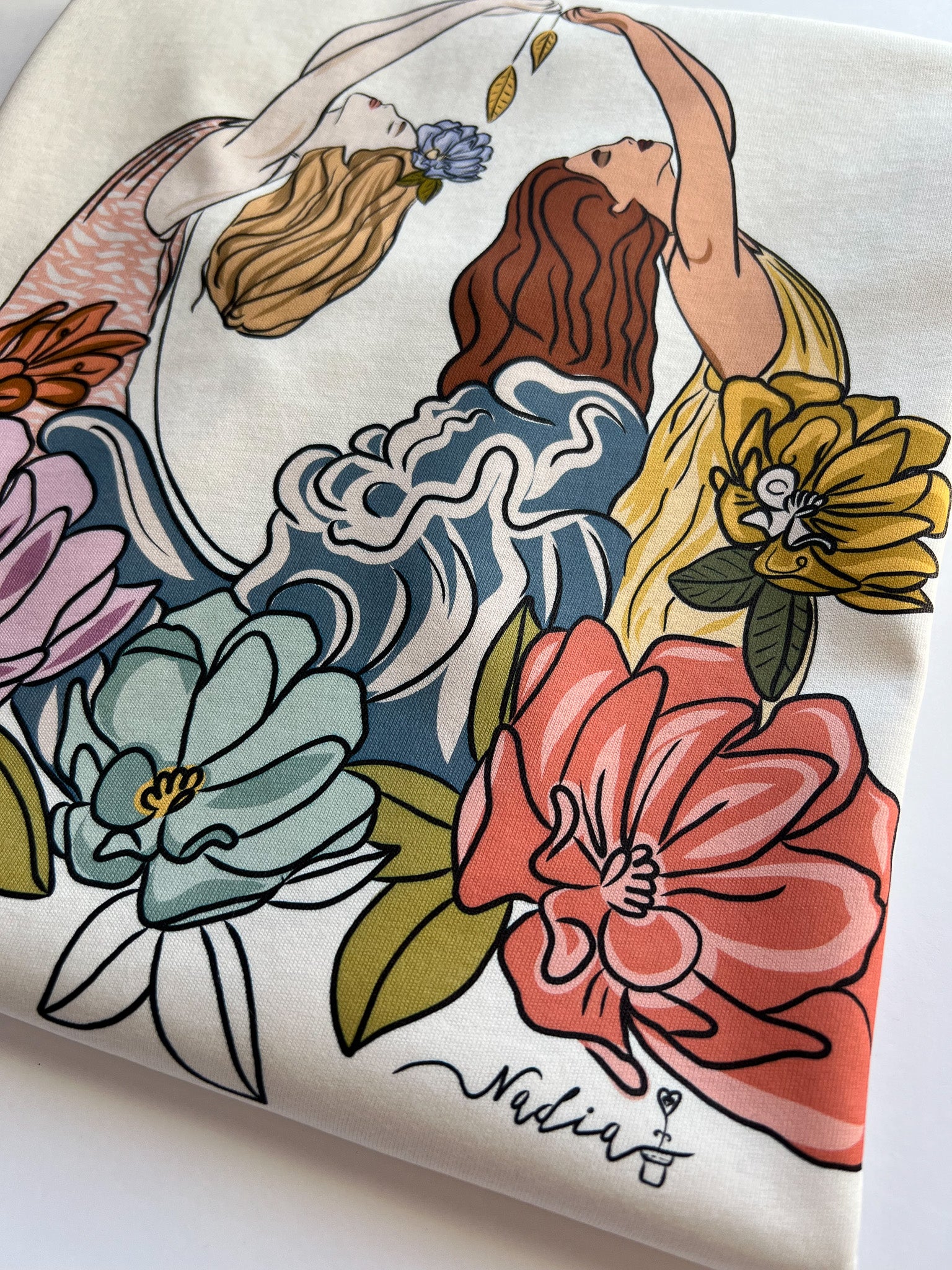 Womenderful is a female-led design studio that creates original and empowering art. This graphic tee features our Sea Goddesses hand-drawn print